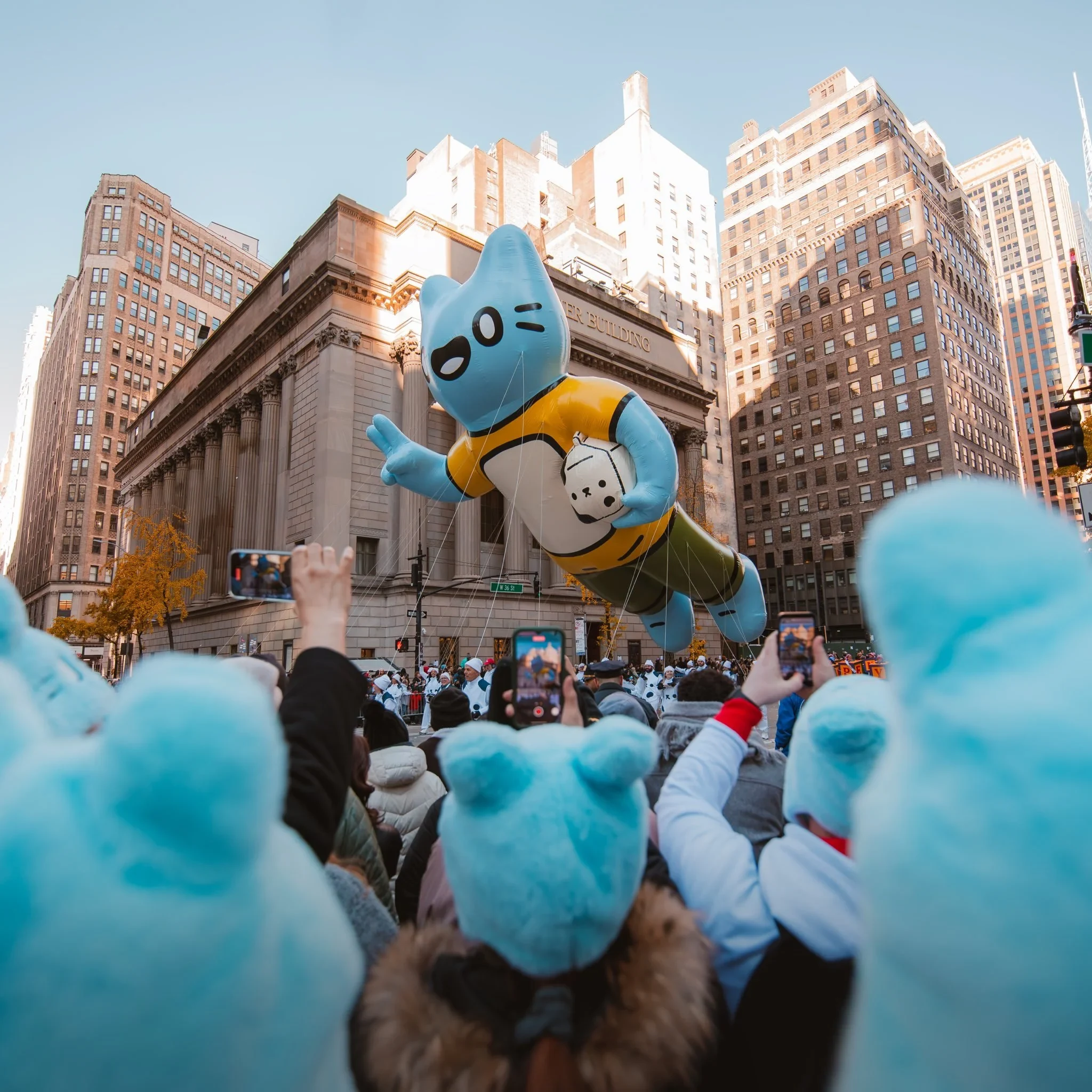 A giant inflatable blue Cool Cats balloon floating above the crowd at the Macy’s Thanksgiving Day Parade in Manhattan.